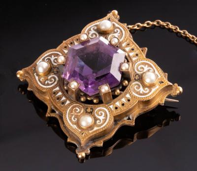 Appraisal: A Victorian amethyst pearl and white enamelled brooch the central