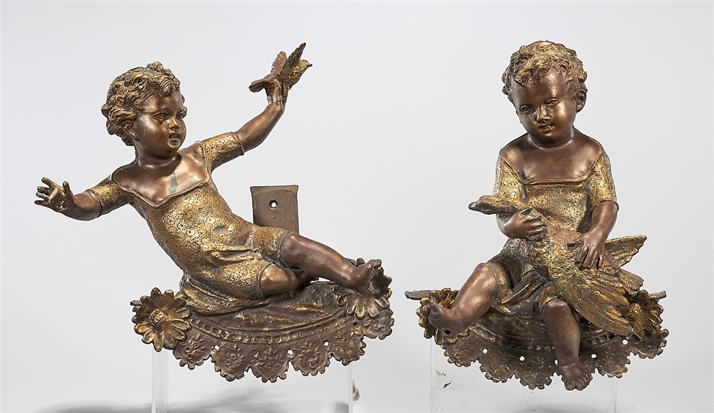 Appraisal: Two polychrome cast iron sculptures of children holding birds with