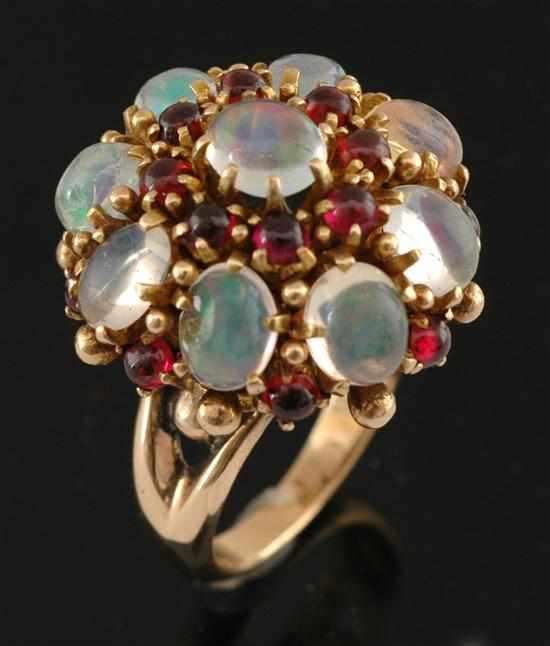 Appraisal: An opal and garnet cocktail ring Of domed cluster design