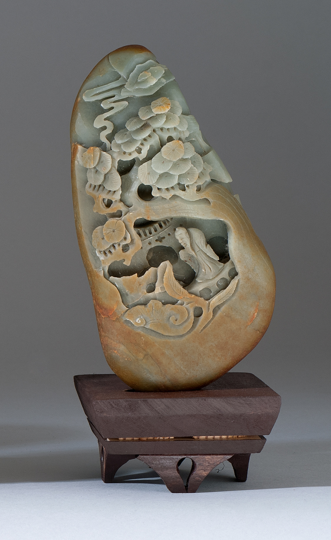 Appraisal: CELADON JADE PEBBLE-FORM MOUNTAIN th CenturyWith carved decoration of a