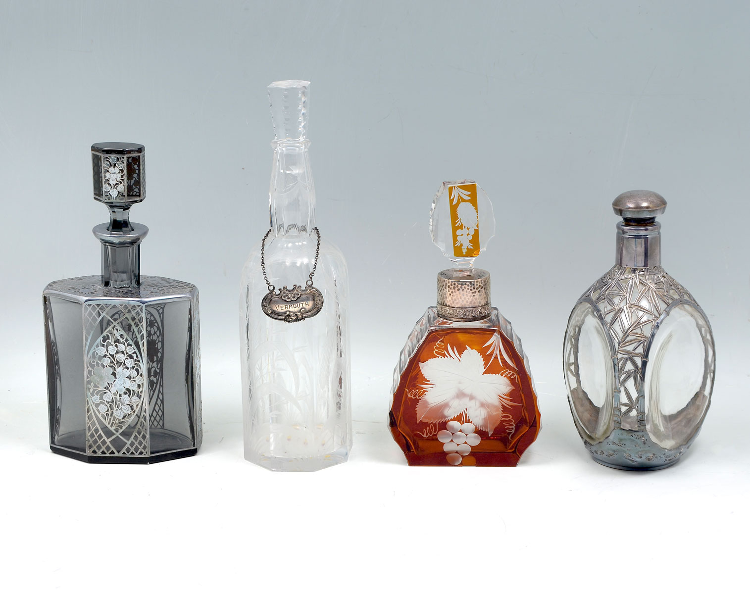 Appraisal: - PC GLASS STERLING DECANTER BOTTLES Comprising - Smoked glass