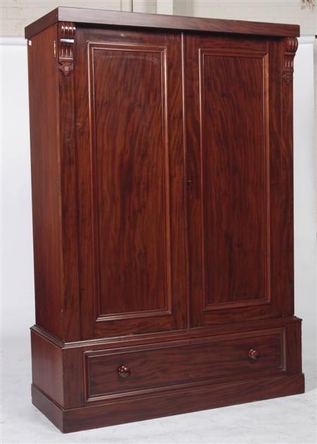 Appraisal: A Victorian mahogany wardrobe the plain cornice over two panelled