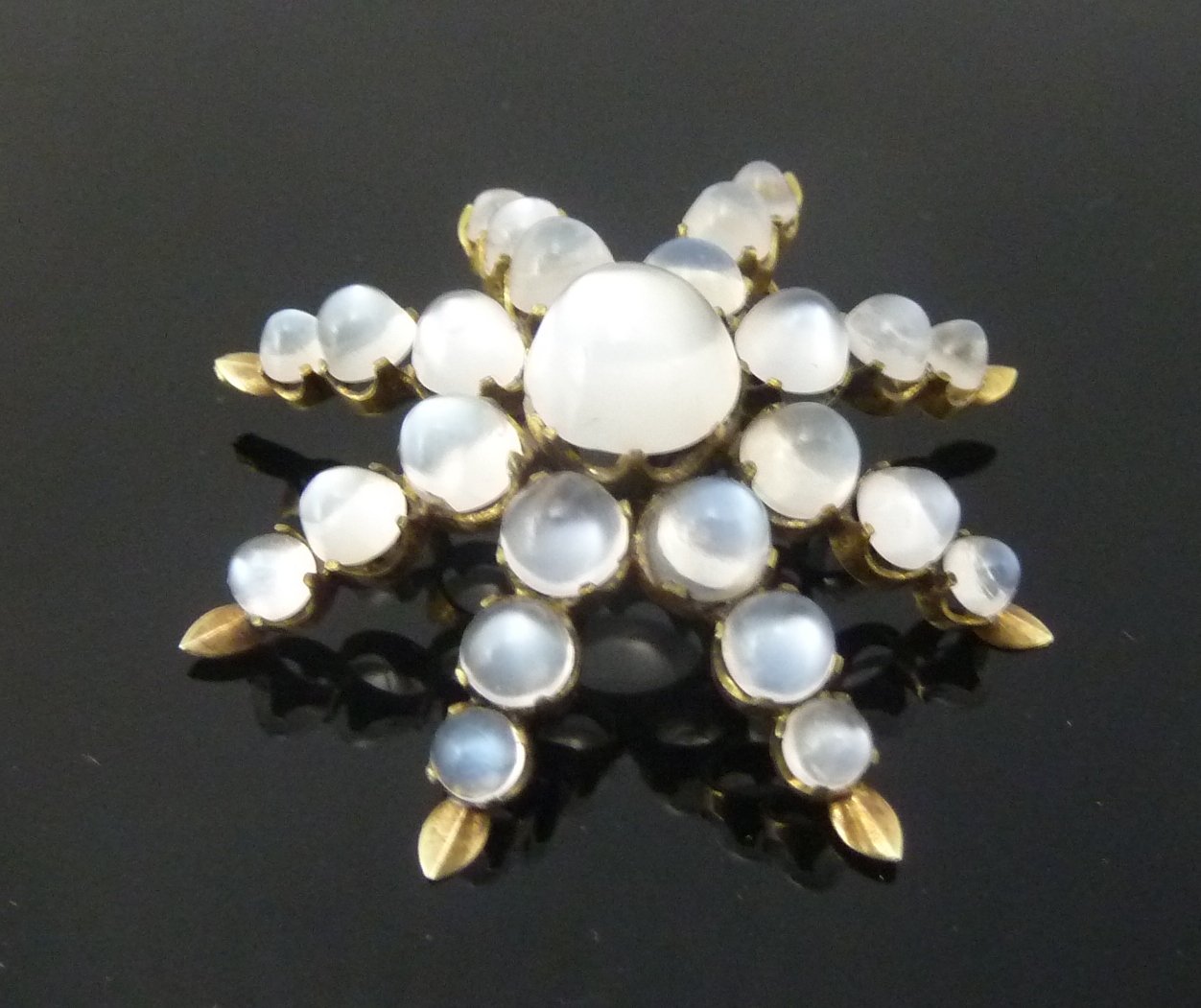 Appraisal: A moonstone starburst brooch cm diameter