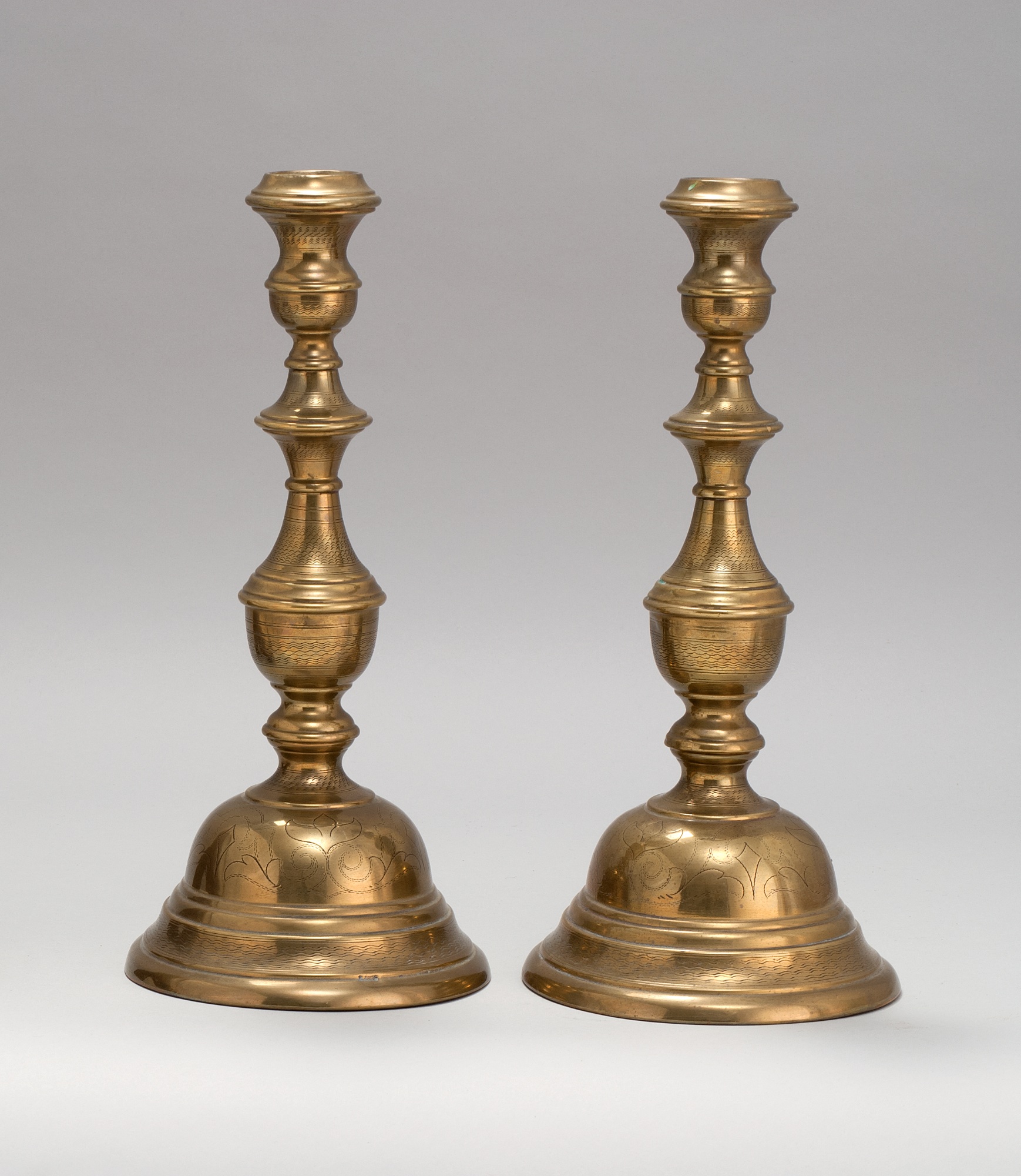 Appraisal: PAIR OF POLISH ENGRAVED BRASS SABBATH CANDLESTICKS th CenturyBy Jakubowski