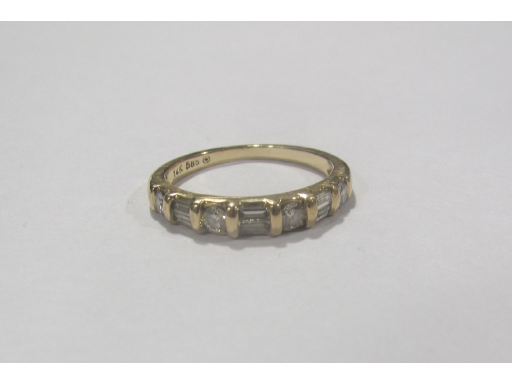 Appraisal: Fourteen carat gold baguette and brilliant cut diamond half hoop