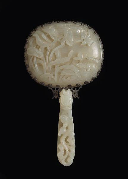 Appraisal: A white jade mounted hand mirror Qing Dynasty The oval-shaped