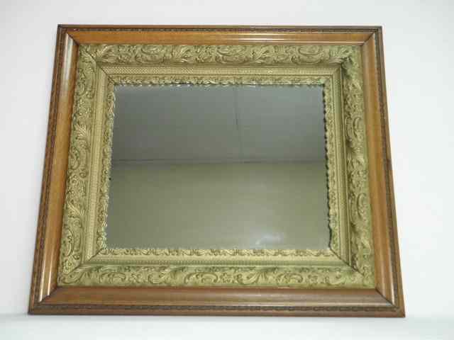 Appraisal: Carved oak wall mirror with a gilt wood border decoration