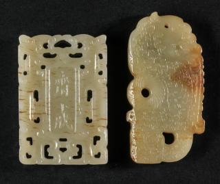 Appraisal: Chinese celadon jade pendants h Two Chinese carved celadon jade