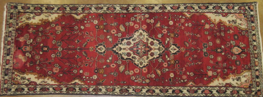 Appraisal: A bordered Hamadan Runner with central lozenge on red ground