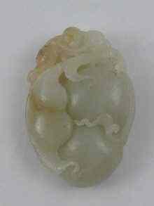 Appraisal: A Chinese jade carving of a monkey on fruit Measuring