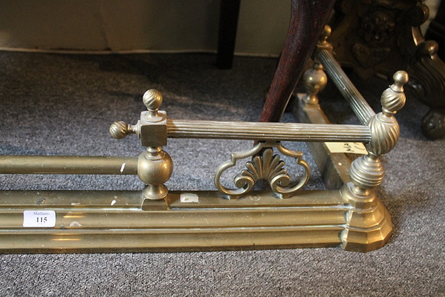 Appraisal: AN EDWARDIAN BRASS FIRE GUARD with turned rails cm across