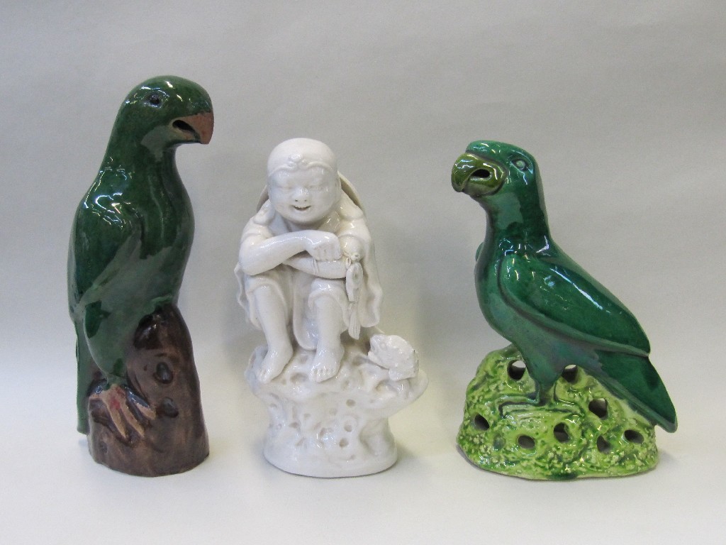 Appraisal: Two Chinese export green glazed parrots and a blanc de