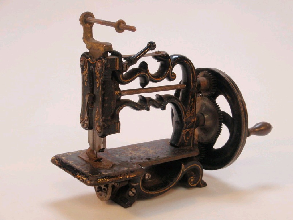 Appraisal: A boxed thC cast iron sewing machine with gilt decoration