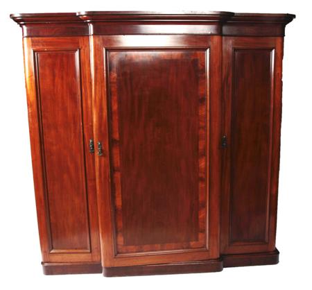 Appraisal: A Victorian mahogany three door breakfront wardrobe the moulded cornice