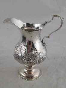 Appraisal: A Georgian silver cream jug with embossed vine decoration Hester