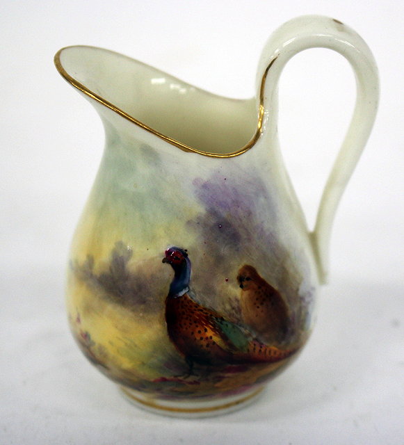 Appraisal: A MINIATURE ROYAL WORCESTER PORCELAIN JUG with hand painted decoration