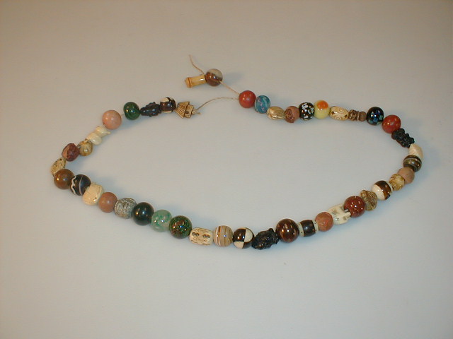 Appraisal: Fifty five ojime beads carved ivory stone semi precious stones