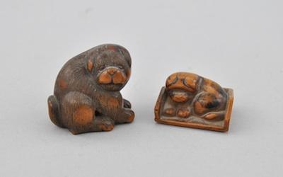 Appraisal: Two Wood Netsukes of Dogs Both of carved wood the