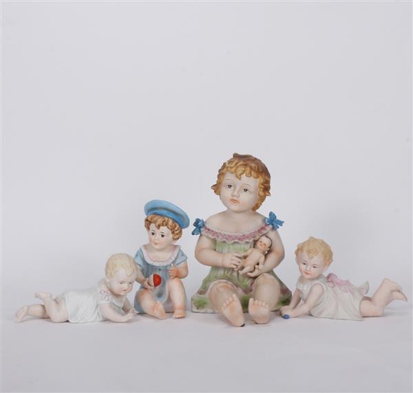 Appraisal: Four German bisque piano babies Largest H x W x