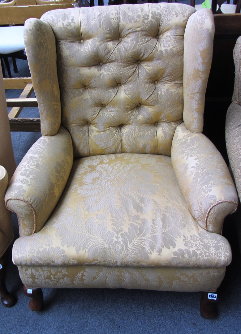 Appraisal: A gold Damask upholstered wing armchair on squat cabriole supports