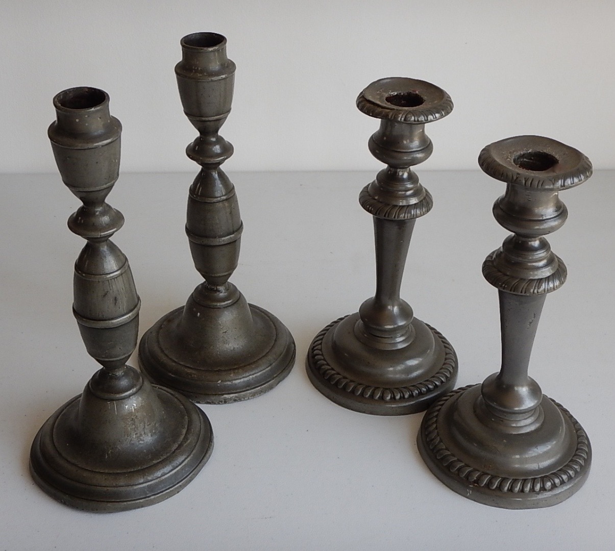 Appraisal: A pair of thC pewter candlesticks with baluster columns and