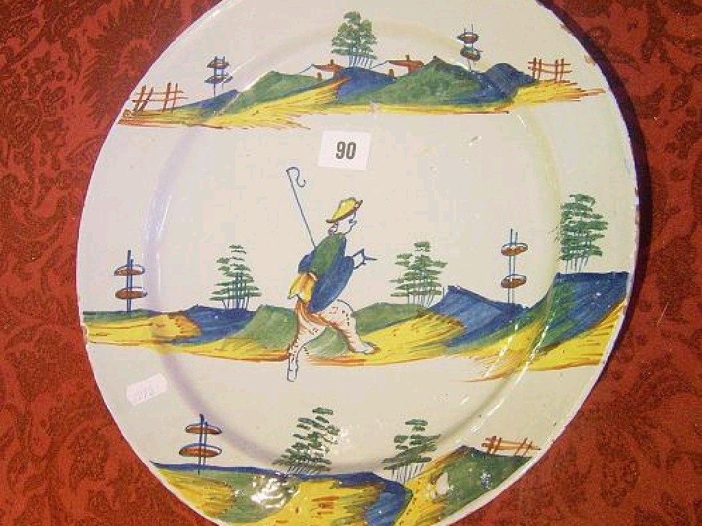 Appraisal: A continental tin glazed earthenware charger with polychrome painted decoration