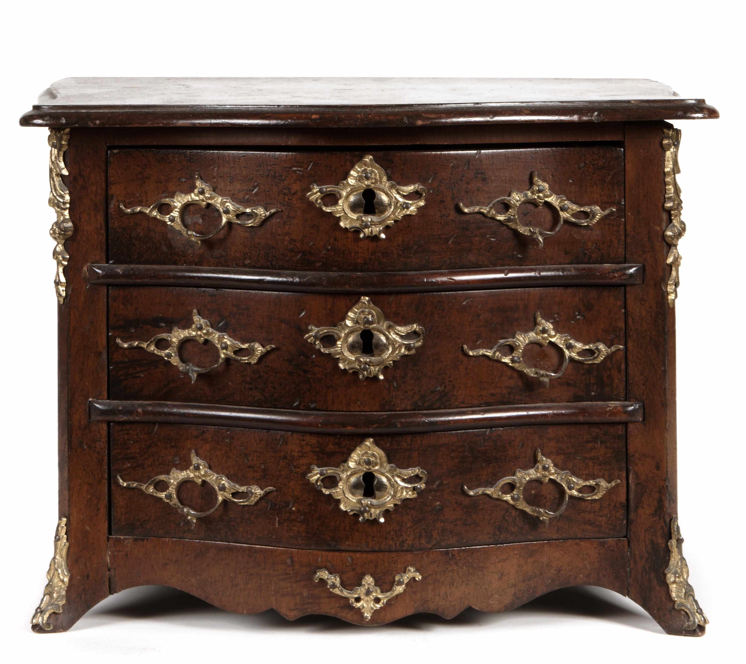 Appraisal: A Continental Rococo miniature hardwood bronze mounted serpentine chest of