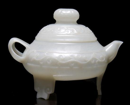 Appraisal: Chinese Translucent Carved Jade Teapot the lidded teapot thinly carved