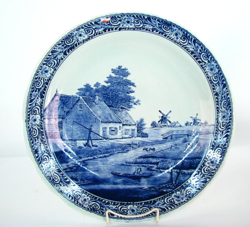 Appraisal: Delfts pottery charger with scenic Holland landscape decoration and floral