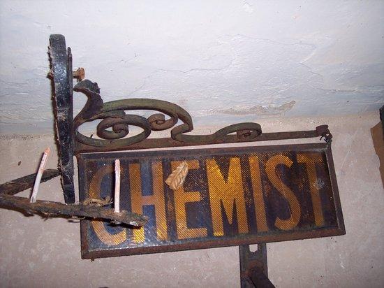 Appraisal: A Chemist's Shop sign hanging from a wrought iron bracket