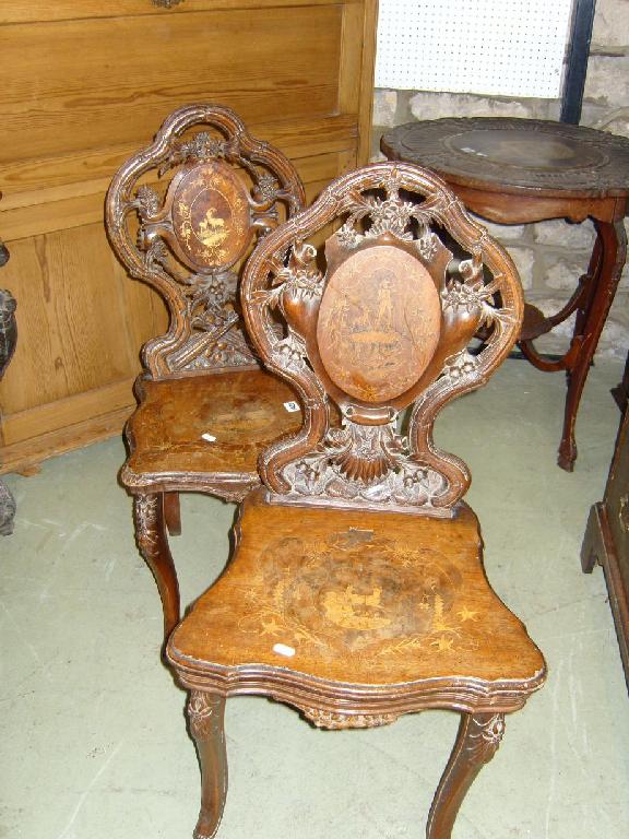 Appraisal: A pair of Tyrolean soft wood hall chairs with profusely