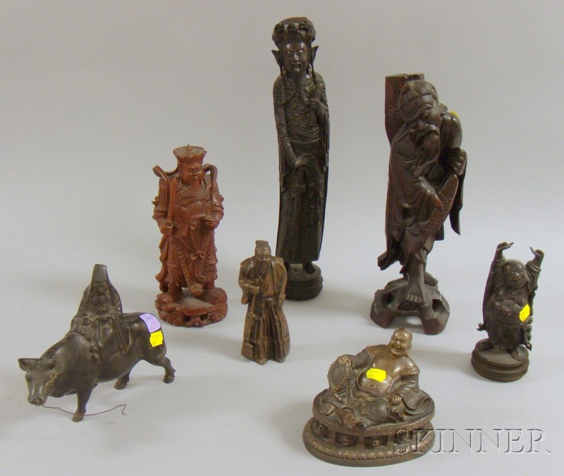 Appraisal: Seven Assorted Asian Metal and Wood Figures a bronze reclining