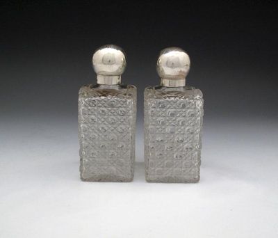 Appraisal: A pair of Victorian silver mounted toilet bottles maker's mark