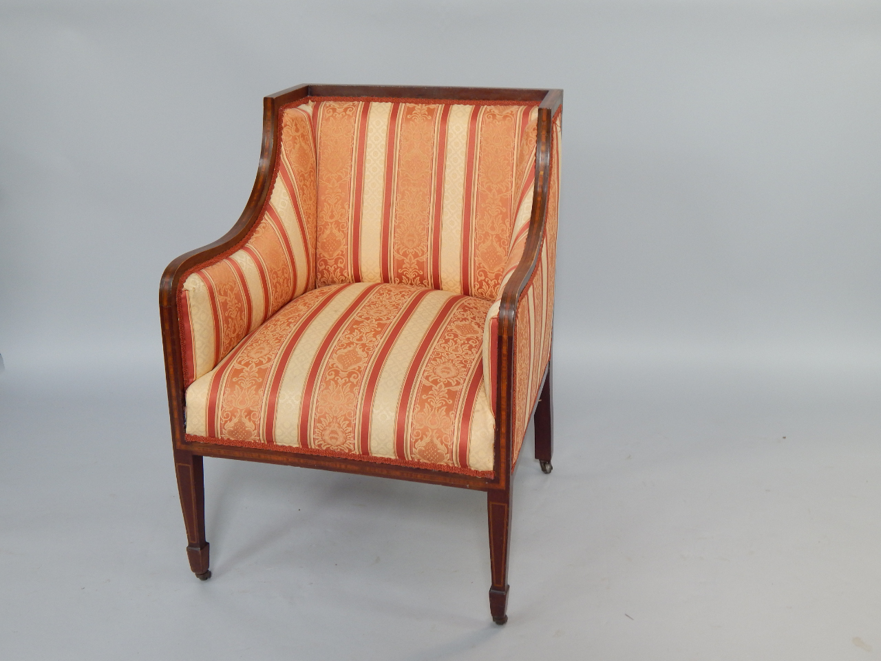 Appraisal: An Edwardian mahogany and satinwood cross banded armchair over stuffed