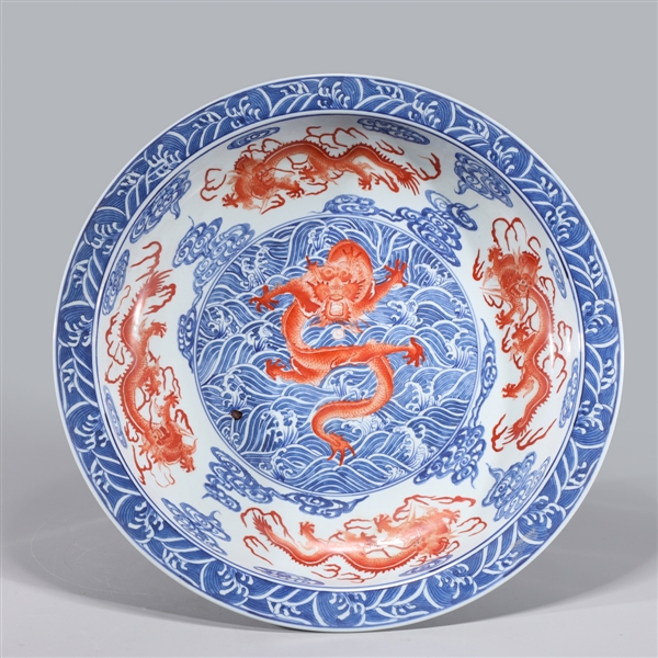 Appraisal: Large blue red and white porcelain charger with dragons amidst