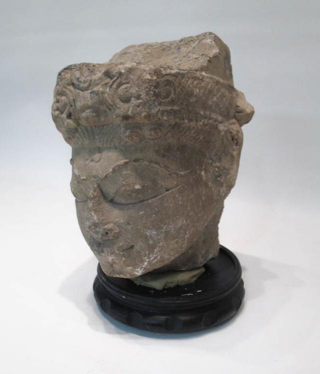 Appraisal: CARVED SANDSTONE HEAD with circular wood base Head height inches