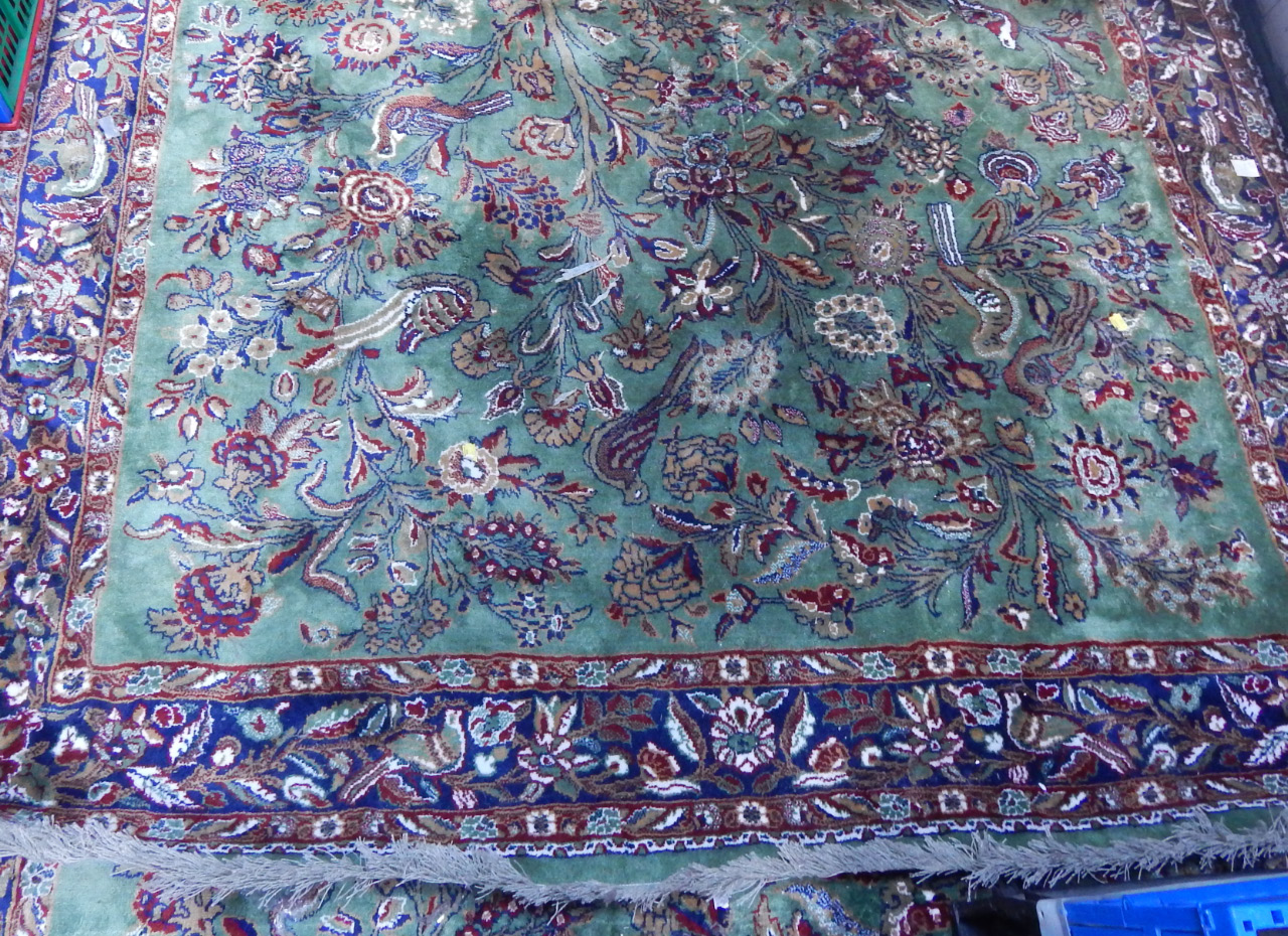 Appraisal: A Shiraz green ground rug decorated with birds and flowers