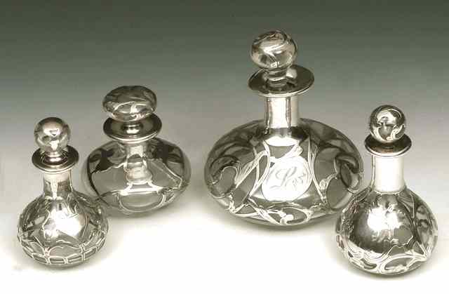 Appraisal: A GROUP OF FOUR SILVER AND GLASS OVERLAID PERFUME BOTTLES