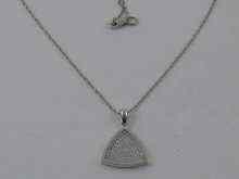 Appraisal: A triangular diamond pendant set in white metal tests carat