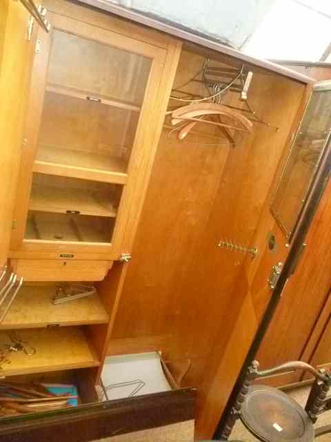 Appraisal: A COMPACTUM DARK BURR WOOD WARDROBE KN model patent No