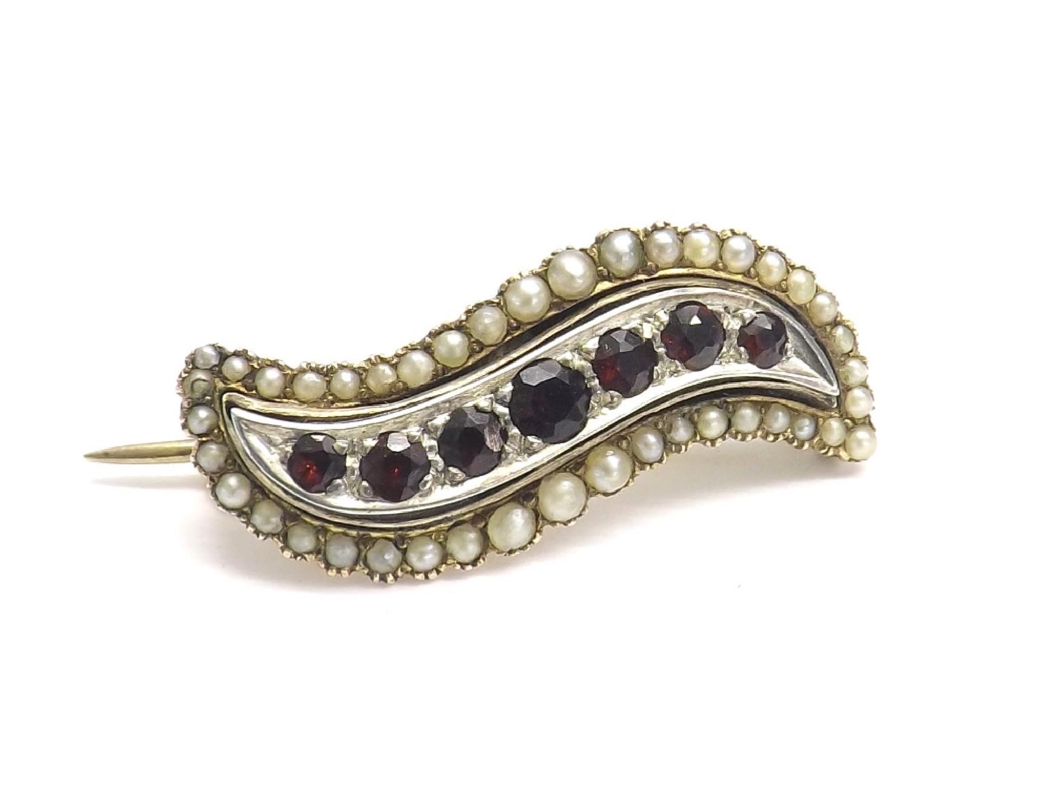 Appraisal: Garnet and seed pearl swirl design gold brooch mm