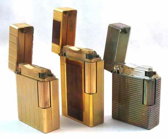 Appraisal: THREE S T DUPONT COLLECTIBLE LIGHTERS Chinese lacquered wood toned