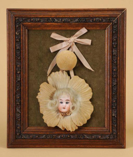 Appraisal: Carved Walnut Frame with German Bisque Doll Head Germany ca