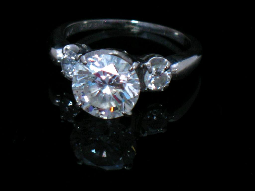 Appraisal: A DIAMOND DRESS RING claw-set to the centre with a