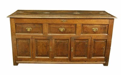 Appraisal: An oak dresser with a middle hinged top to a