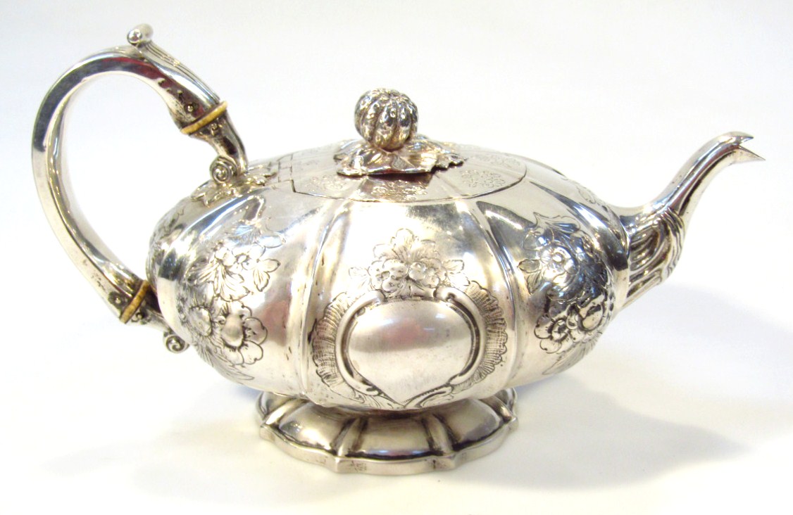 Appraisal: An Irish silver tea pot by Edward Powell of compressed