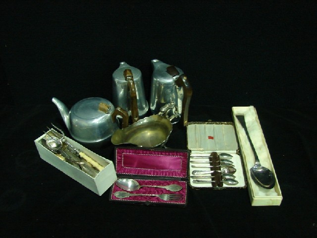 Appraisal: A silver plated sauceboat together with two coffee pots and