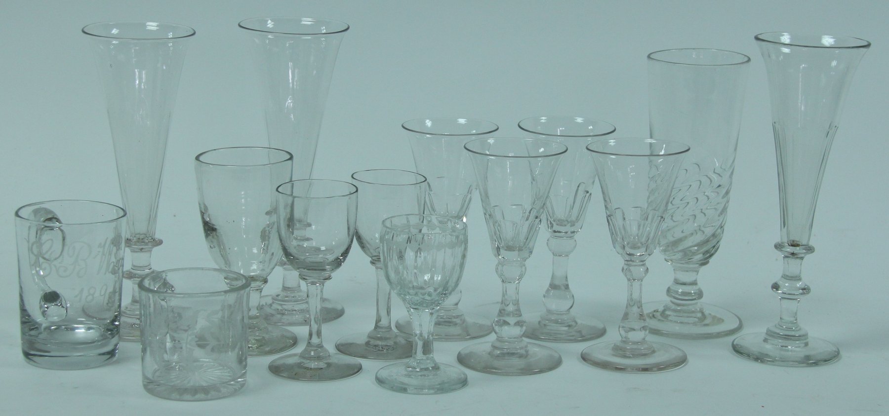 Appraisal: Three glass flutes with knopped stems and sundry stem wines