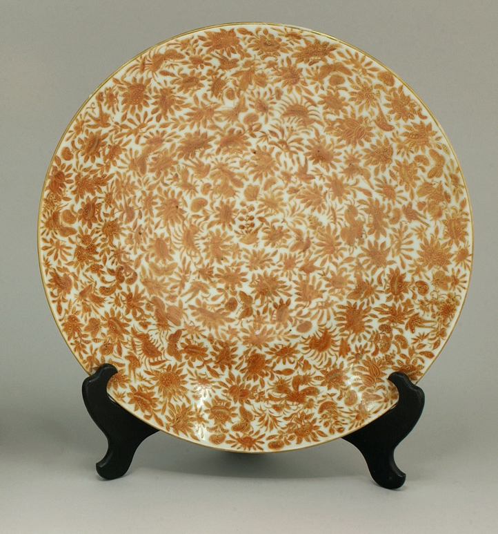 Appraisal: CHINESE EXPORT PORCELAIN CHARGER Mid- th CenturyWith orange-sepia bird and