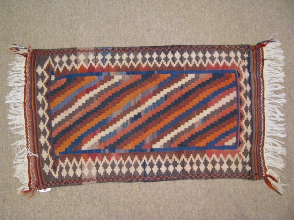 Appraisal: Turkish hand knotted wool carpet with orange blue and brown